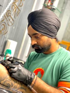 Tattoo Artist, Pardeep Singh making a tattoo.