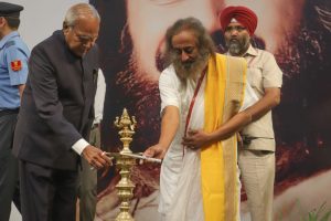 Gurudev Sri Sri Ravi Shankar and Governor Punjab Sh. Banwari Lal Purohit lighting the lamp at the 'Mahasatsang' held at the site of 'The Wellness City' coming up on the Chandigarh - Patiala Road.