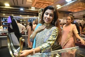 A visitor trying jewellery at the stall of Omara Fine Jewellery at The Indian Bride Exhibition.