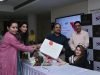 Principal NIIFT, Dr Poonam Thakur, Jashan Boparai from Arzoe, Sibin C, DG NIIFT & Vishav Bandhu Monga ,Dir , NIIFT give a packed designer dress to Somya Thakur(sitting) who will represent India in Miss Wheelchair World..jpg