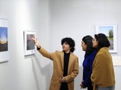 A 17-year-old photographer Idant Dikshit explaining details of his photos to visitors at his solo 2 day photo exhibition - 'Lessons from a Passport' at Punjab Kala Bhawan, Sector 16, Chandigarh.