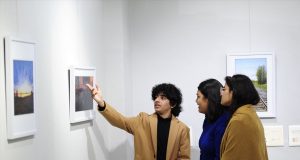 A 17-year-old photographer Idant Dikshit explaining details of his photos to visitors at his solo 2 day photo exhibition - 'Lessons from a Passport' at Punjab Kala Bhawan, Sector 16, Chandigarh.