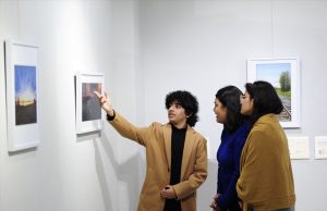 A 17-year-old photographer Idant Dikshit explaining details of his photos to visitors at his solo 2 day photo exhibition - 'Lessons from a Passport' at Punjab Kala Bhawan, Sector 16, Chandigarh.