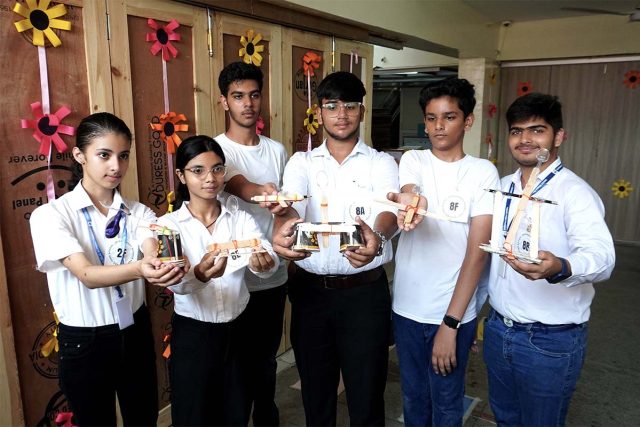 Students showing 'catapults' they prepared at a science event held as part of the 'Annual Vivek Fiesta '24'